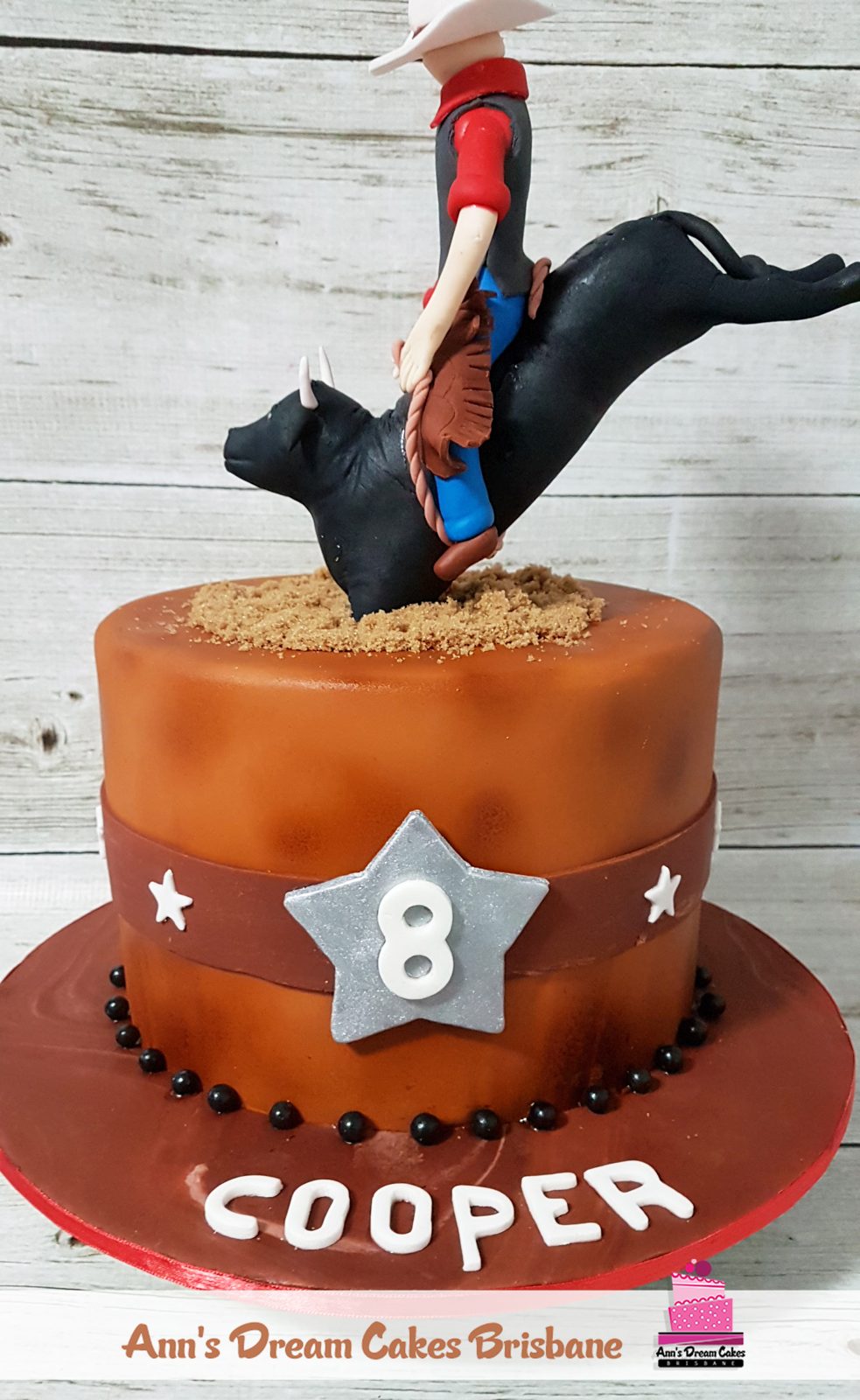 Rodeo themed 8th birthday cake with a fondant bull rider
